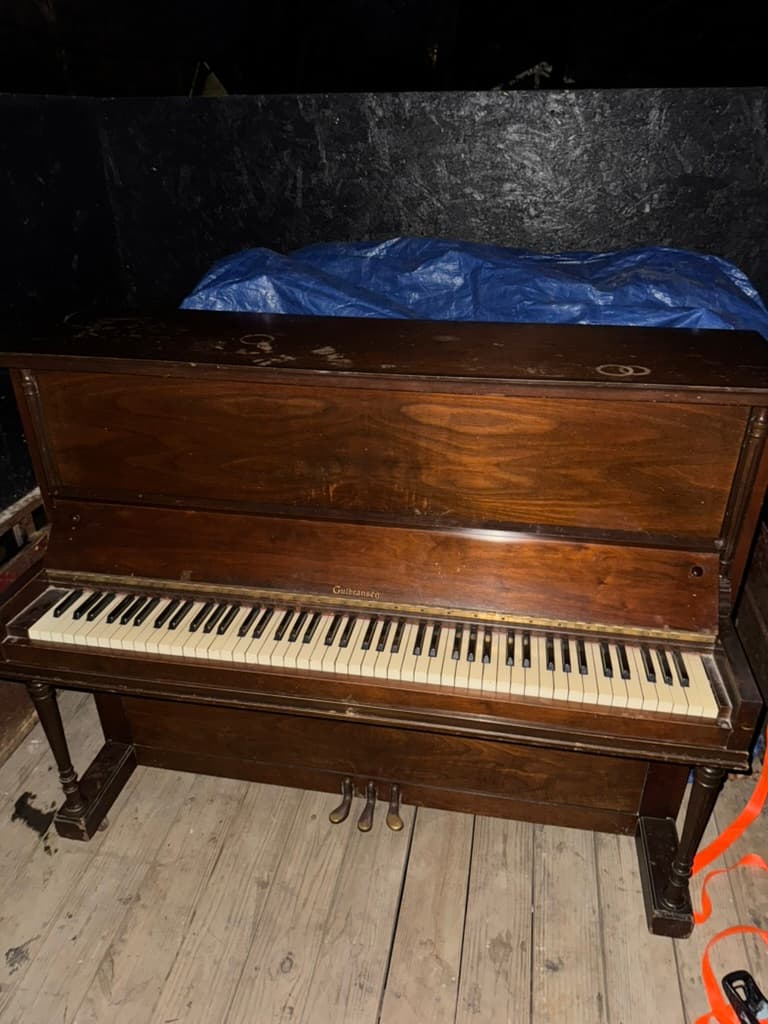 Old upright piano being removed during estate cleanout in Lake County, Ohio
