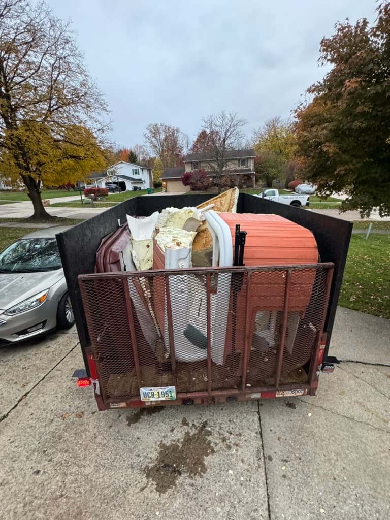 Junk removal trailer fully loaded with debris hauled from Lake County home